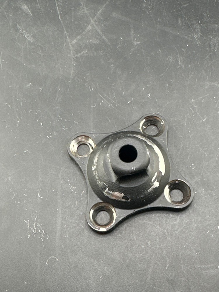 Prosthetic 4 hole male pyramid adapter component part.