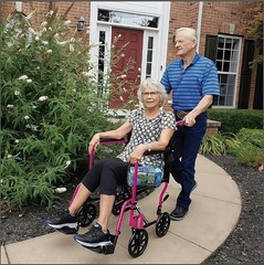 Safe and Stylish Pink Folding Wheelchair with Padded Armrests – 300 lbs Capacity