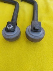 A PAIR OF QUICKIE V-121 MOTORIZED WHEELCHAIR ANTI-TIPPERS With Bolts