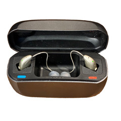 Left and Right Resound GN Hearing Aids and charging station w/cord.