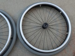 Out Front Shadow Spoke Wheelchair Wheel Pair 22″ 501mm Solid Tire Alum Handrim