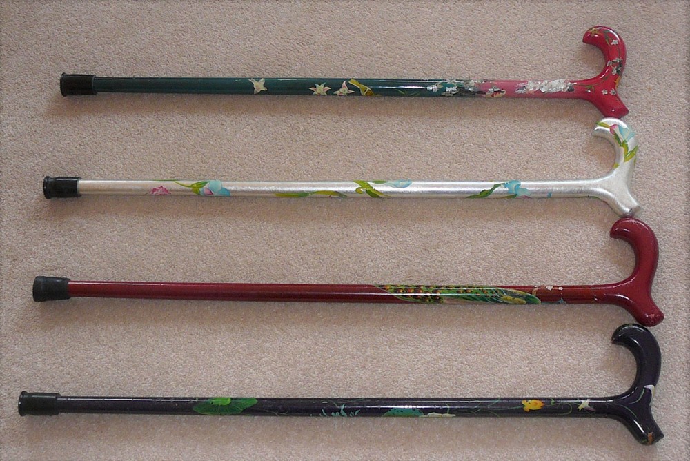 Set of four hand painted canes, each approximately 31″ tall. Gently worn