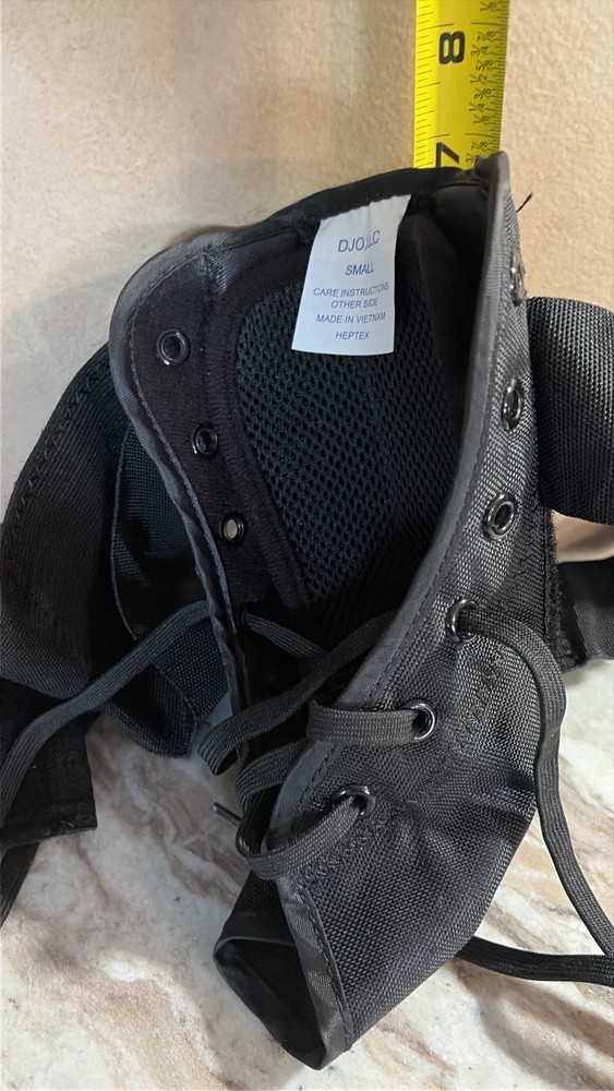 This is a black DJO LLC „Heptex“ medical ankle brace, size small.