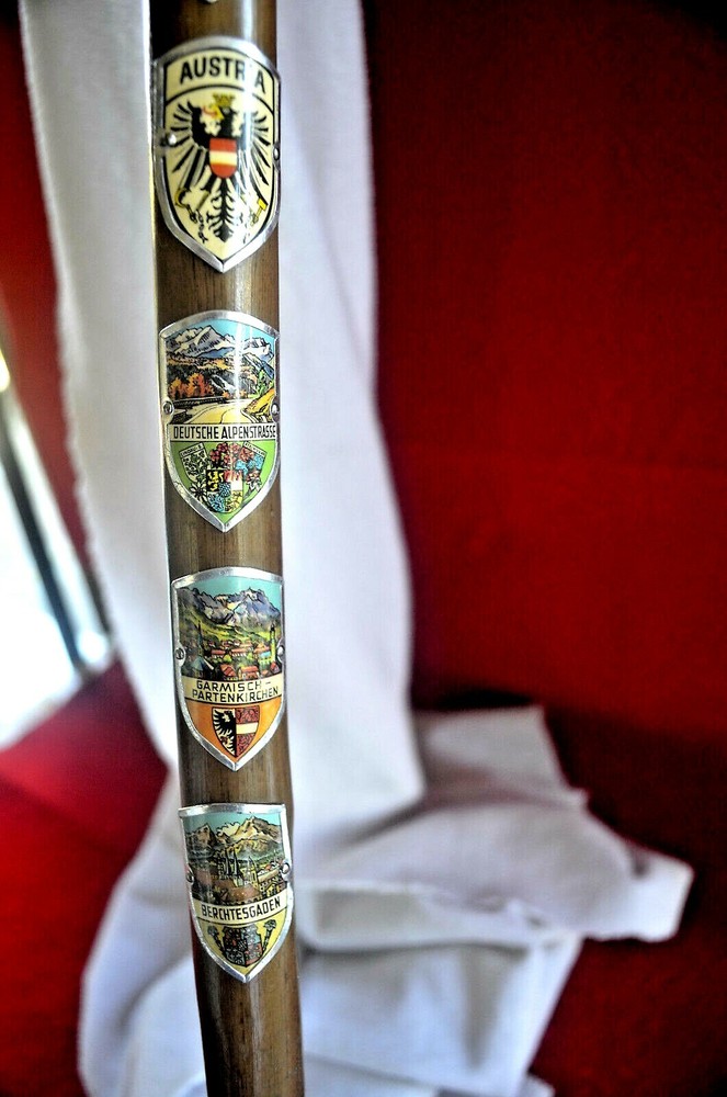WOOD CANE WITH ELEVEN (11 ) HAND PAINTED ENAMEL METAL BADGE’S (GERMANY )