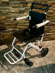 Lightweight transport chair, weighing only 15 pounds. Brand new, in the box.