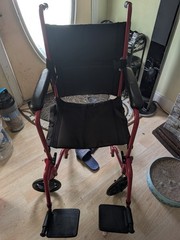 red and black foldable transportable wheelchair for seniors