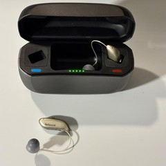 Left and Right Resound GN Hearing Aids and charging station w/cord.