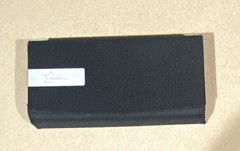 Starkey branded hearing aid hard case durable black mesh-like exterior.