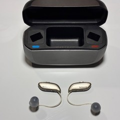 Left and Right Resound GN Hearing Aids and charging station w/cord.