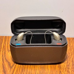 Left and Right Resound GN Hearing Aids and charging station w/cord.