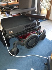 Electric wheel chair red and black Quickie Q500M promaybe has 2 hours on it